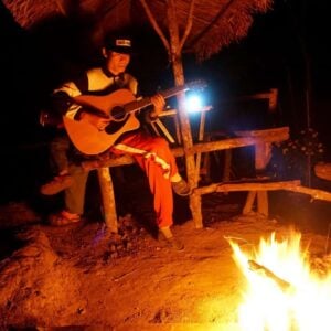 Playing guitar by the bonfire in Doi Inthanon National Park.