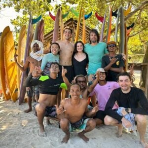 Group of people on beach with surfboards
